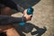 Close-up of male athlete hands holding a blue bottle full of fresh water for rehydrating after heavy cardio and bodybuilding