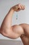 Close-up of male biceps. Unrecognizable male bodybuilder puts himself an injection of testosterone. Faceless athlete