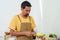 Close-up male chef holding a paring knife Use a knife to peel a large mango. Fast paring knife with knife skill when used