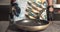 Close-up of male chefs hands in gloves pouring oil and putting finely chopped onion in a frying pan in the kitchen.