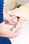 Close-up of male chiropractor hands massaging calves of a small patient. A little boy at the reception of the procedure