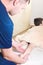 Close-up of male chiropractor hands massaging calves of a small patient. A little boy at the reception of the procedure