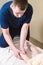 Close-up of male chiropractor hands massaging calves of a small patient. A little boy at the reception of the procedure