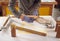 Close Up Of Male Craftsman In Workshop Assembling Hand Built Sustainable Bamboo Bicycle Frame