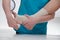 Close-up of male doctor bandaging foot of female patient