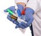 Close up of male doctor hands in protective gloves holding  syringes, antiseptic, thermometer over white background