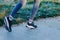 Close-up of male feet in trainers going to run on the street with yellow leaves on the ground