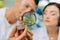 Close up of male and female agriculturists looking at greens