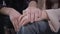 Close-up of male and female Caucasian hands holding and stroking each other. Unity and support of young couple or family