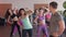 Close-up of male fitness trainer. He looks at a group of girls who train in an aerobic gym