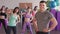 Close-up of male fitness trainer. He looks at a group of girls who train in an aerobic gym