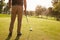 Close Up Of Male Golfer Lining Up Tee Shot On Golf Course