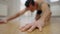 Close-up of male hand with blurred Middle Eastern man exercising at background. Unrecognizable muscular sportsman