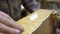 Close up of male hand cleaning a light wooden stand with a rag