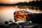 A close up of a male hand elegantly gripping a glass of whiskey