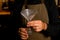 close-up of a male hand holding an empty transparent frosted martini wine glass