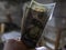 Close up of male hand holds two banknotes of hundred dollars. new hundred-dollar bills.Money USA dollar banknotes