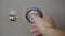 Close-up of male hand, introduces combination security code of safe lock.