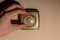 Close up of a male hand on a old fashioned central heating thermostat