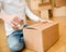 Close up of male hand packing cardboard box