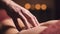 Close-up male hand of a professional physiotherapist masseur doing lumbar massage to a female patient in a massage