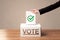 Close up of male hand putting vote into a ballot box