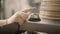 Close up of male hand ringing the bell and calls a waiter in restaurant