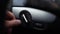 Close-up of male hand turn off and auto mode of switch light button of car