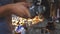 Close up male hands of adult welder cutting steel using electric grinding wheel in workshop. Arms of professional