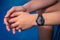 Close up of male hands and arms wearing a black automatic steel wristwatch.