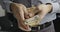 Close-up of male hands counting a pack of fifty euro bills.