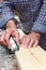 Close up of male hands doing woodwork using tools