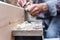 Close up of male hands doing woodwork using tools