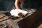 Close-up of male hands holding roll with vegetables near camping grill.