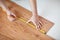 Close up of male hands measuring flooring