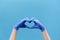 Close up of male hands in medical protection gloves making heart symbol as a way to show thank gratitude to doctors and nurses