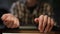 Close-up male hands with neat aesthetic manicure indoors. Front view blurred unrecognizable Caucasian young man sitting