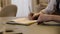 Close-up of male hands and notebook of unidentified young writer.