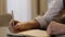 Close-up of male hands and notebook of unidentified young writer.