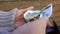 Close-up of the male hands opening a fresh delicious oyster with a special knife