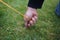 Close up of male hands pegging down a tent on grass.