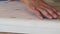 Close-up of male hands polishing wooden step with sandpaper