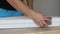 Close-up of male hands polishing wooden step with sandpaper