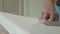 Close-up of male hands polishing wooden step with sandpaper