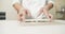 Close up of male hands of professional chef in gloves cooking delicious sushi rolls in restaurant kitchen.