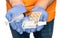 Close up of male hands in protective gloves holding pills, ampule, syringe and antiseptic over white background