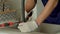 Close-up of male hands in protective gloves repairing kitchen faucet with tools