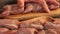 Close-up of male hands putting raw marinated quails on the skewers