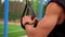 Close up of male hands with smart watches holding rubber belt handles, ready for outdoors training