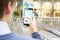 Close up of male hands using cellphone with abstract emails on blurry outdoor background. Likes, social media and communication